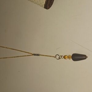 Gold tone necklace with brown and amber pendant
